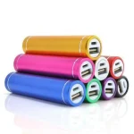 Stack of colorful USB power banks arranged in a pyramid showing multiple charging ports at the ends | PricZone