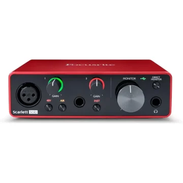 Front view of a red Focusrite Scarlett Solo audio interface with two gain knobs, input jacks, and monitor control on a dark panel.
