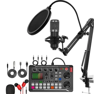 Podcasting setup featuring a condenser mic with pop filter on an adjustable arm, a large audio interface/mixer with colorful pads, and multiple cables and accessories