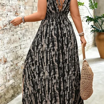 Woman seen from behind in a black and white patterned sleeveless maxi dress with a back tie carrying a woven straw bag by her side | PricZone