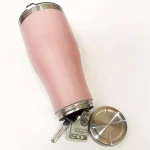 Close up of a pink stainless steel travel mug with a metal lid accompanied by keys and a folded $20 bill on a white background | PricZone