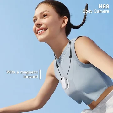 Smiling woman outdoors wearing a white H88 body camera on a magnetic lanyard around her neck.