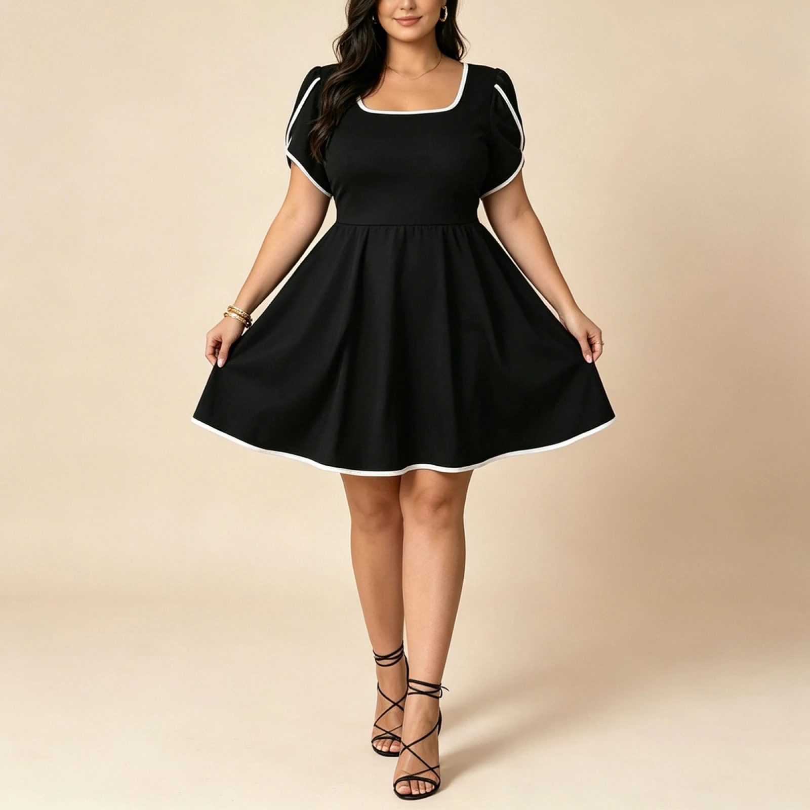 Lace Sleeveless VNeck Cocktail Dress Plus Size 4 | PricZone Woman wearing a black fit and flare dress with white piping posing with hands on the skirt edge | PricZone