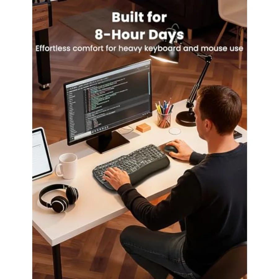 Person coding at a desk with a large monitor, promoting comfort during long keyboard and mouse use.