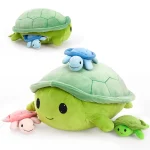 Three soft plush turtlesa large green adult turtle with a blue baby turtle on its back plus a pink baby and a small green turtle on a white background | PricZone