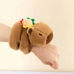 Brown plush bear finger puppet resting on a hand with a small decorative pastry accessory on its back | PricZone