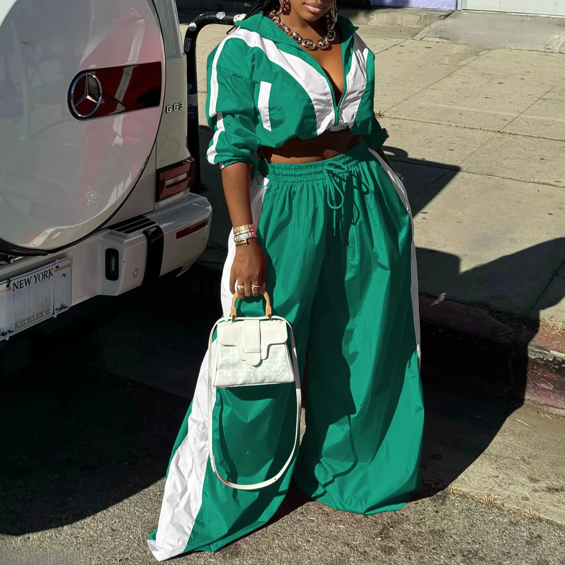 Xtocean Active Patchwork Womens 2Piece Tracksuit Set 5 | PricZone Woman in green and white tracksuit beside a white Mercedes SUV holding a small white handbag | PricZone