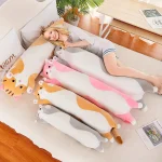 Woman lounging on a beige sofa tucked under pastel unicorn blankets in a bright living room with a plant nearby | PricZone