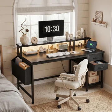 Desk setup in a sunlit bedroom: monitor shows 10:30 with decorative objects on the desk and a rolling white chair nearby in front of a window.