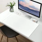 Xxl Large Gaming Desk Mat with NonSlip Base and Smooth 4 | PricZone White minimalist desk setup with a large monitor glass vase of white tulips a pair of glasses and a small speaker on a white desk mat | PricZone