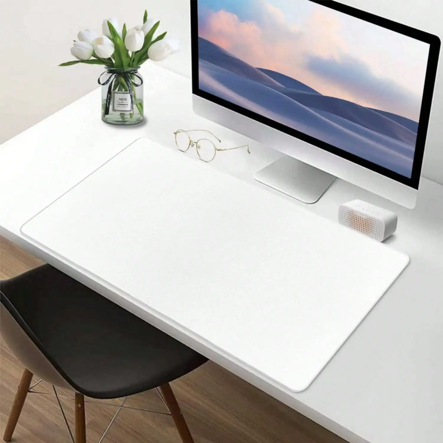 Xxl Large Gaming Desk Mat with NonSlip Base and Smooth 4 | PricZone White minimalist desk setup with a large monitor glass vase of white tulips a pair of glasses and a small speaker on a white desk mat | PricZone