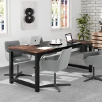 Modern conference room with a dark wood table four gray swivel chairs two laptops a tray of cups and a plant | PricZone