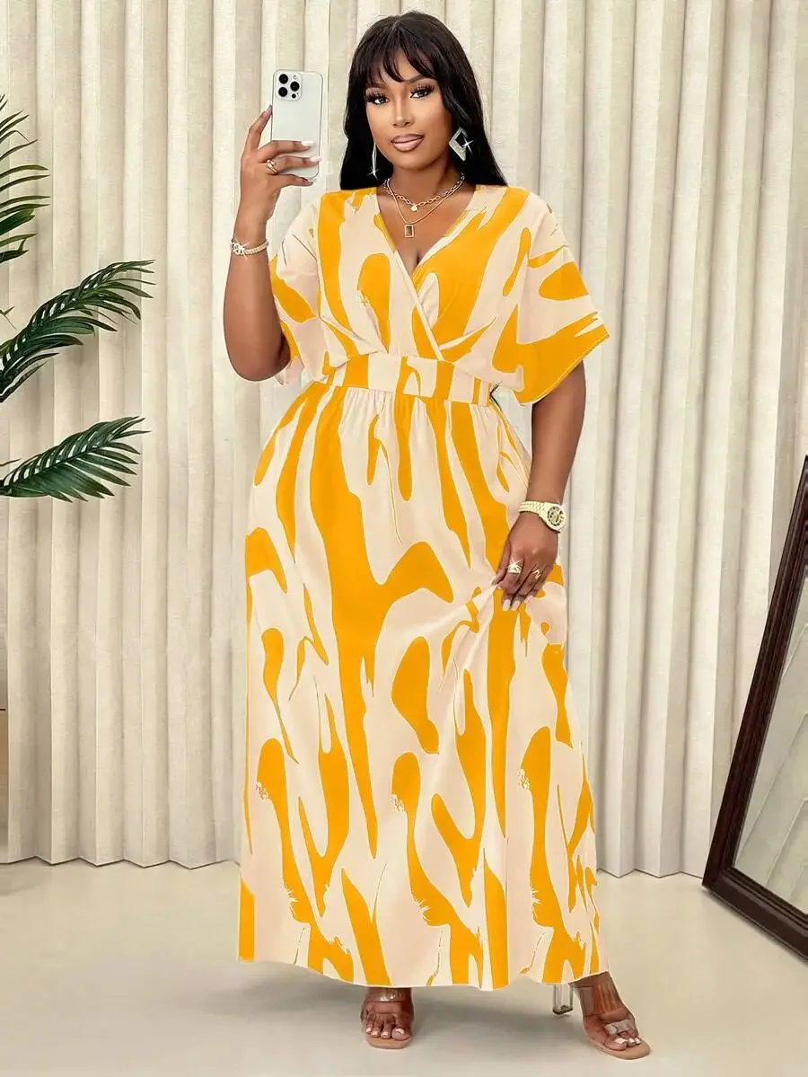 Plus Size Tropical Leaf Print Summer Maxi Dress 2 | PricZone Woman in a bold yellow and cream abstract print maxi dress takes a selfie holding a white smartphone in front of a light backdrop | PricZone