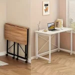 62X1575Inch Foldable Rolling Laptop Desk with XShaped 1 | PricZone Folded wooden desk with a black frame sits against the wall beside a white rolling desk with a laptop and books | PricZone