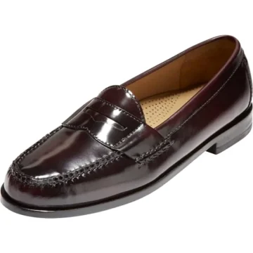 Dark burgundy patent leather penny loafer with apron-toe stitching and low heel (men's dress shoe).