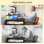 Man working at a desk with multiple screens one showing a horse riding scene in a bright homeoffice setup | PricZone