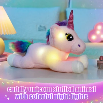 Soft pink unicorn plush with a rainbow mane and glittery pink horn, resting on a pastel surface with colorful night lights in the background; text on image reads 'cuddly unicorn stuffed animal with colorful night lights'
