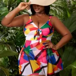 Geometric Print Plus Size Swim Dress for Beach 5 | PricZone Woman in a multicolor geometric dress and wide brim straw hat posing among tropical plants | PricZone