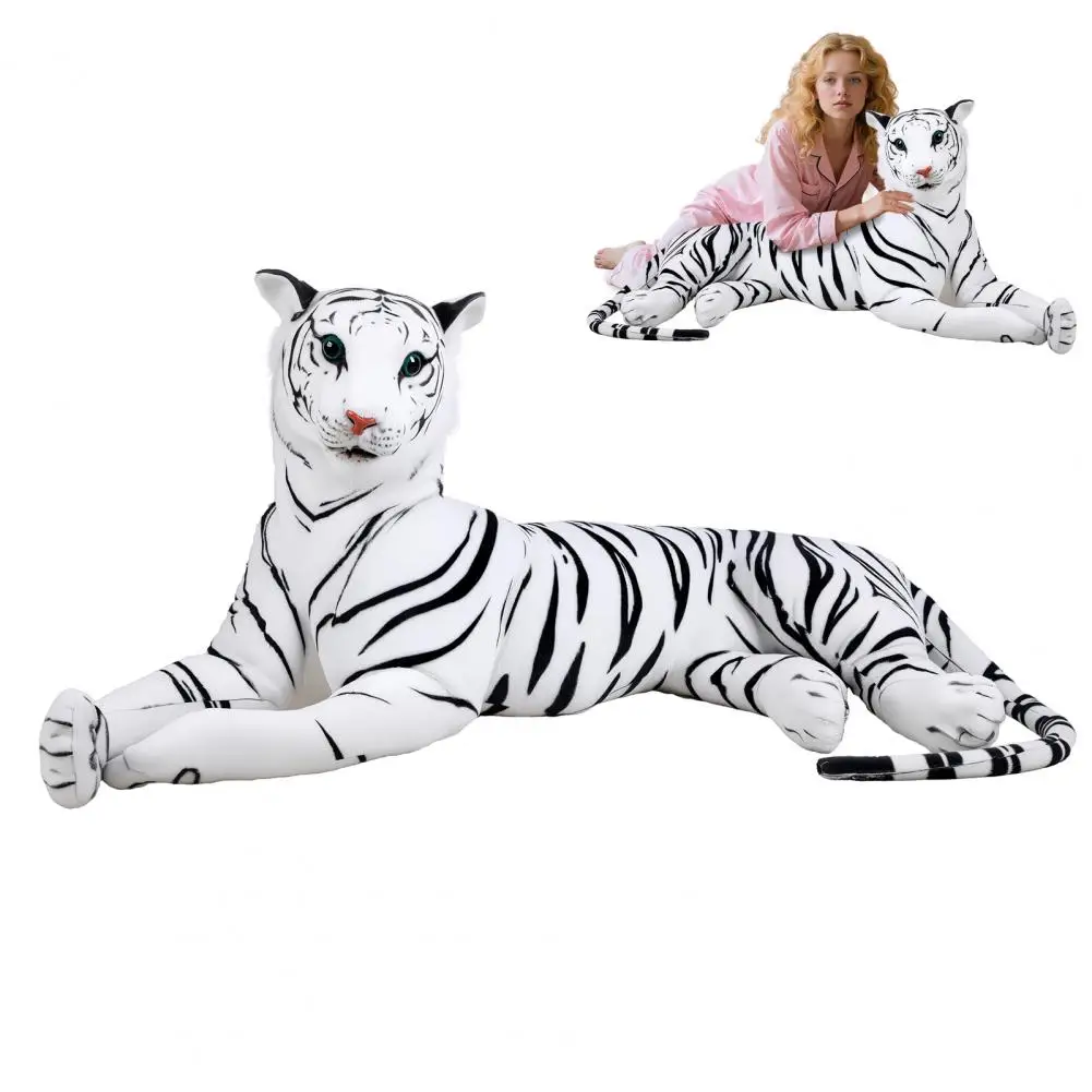 Large white tiger plush lying down with a woman in pink resting on its back.