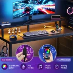A modern computer setup with a curved monitor displaying a fast car chase on a neon lit blue and red background keyboard headphones and gadgets on a carbon fiber desk | PricZone