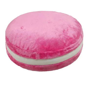 Pink round plush cushion with a white cream colored middle seam resembling a soft macaron pillow | PricZone