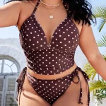 Plus Size Polka Dot Halter Tie Beach Swimwear 3 | PricZone Woman wearing a brown polka dot bikini top with side ties layered necklaces outdoors under sunny sky | PricZone