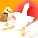 50Cm Goose Plush Toy Soft Stuffed Animal Couch Pillow Bed 5 | PricZone White plush figure in front of a large red heart shaped pillow on a bright orange background with a daisies basket nearby | PricZone