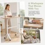 Small Standing Desk Adjustable Height with Wheels 6 | PricZone Person standing at a height adjustable desk laptop open coffee mug nearby by a window with greenery outside creating a bright workspace | PricZone