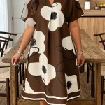 Plus Size Summer Floral Print VNeck Batwing Dress 6 | PricZone Woman wearing a knee length brown dress with oversized white floral patterns in a kitchendining room setting | PricZone