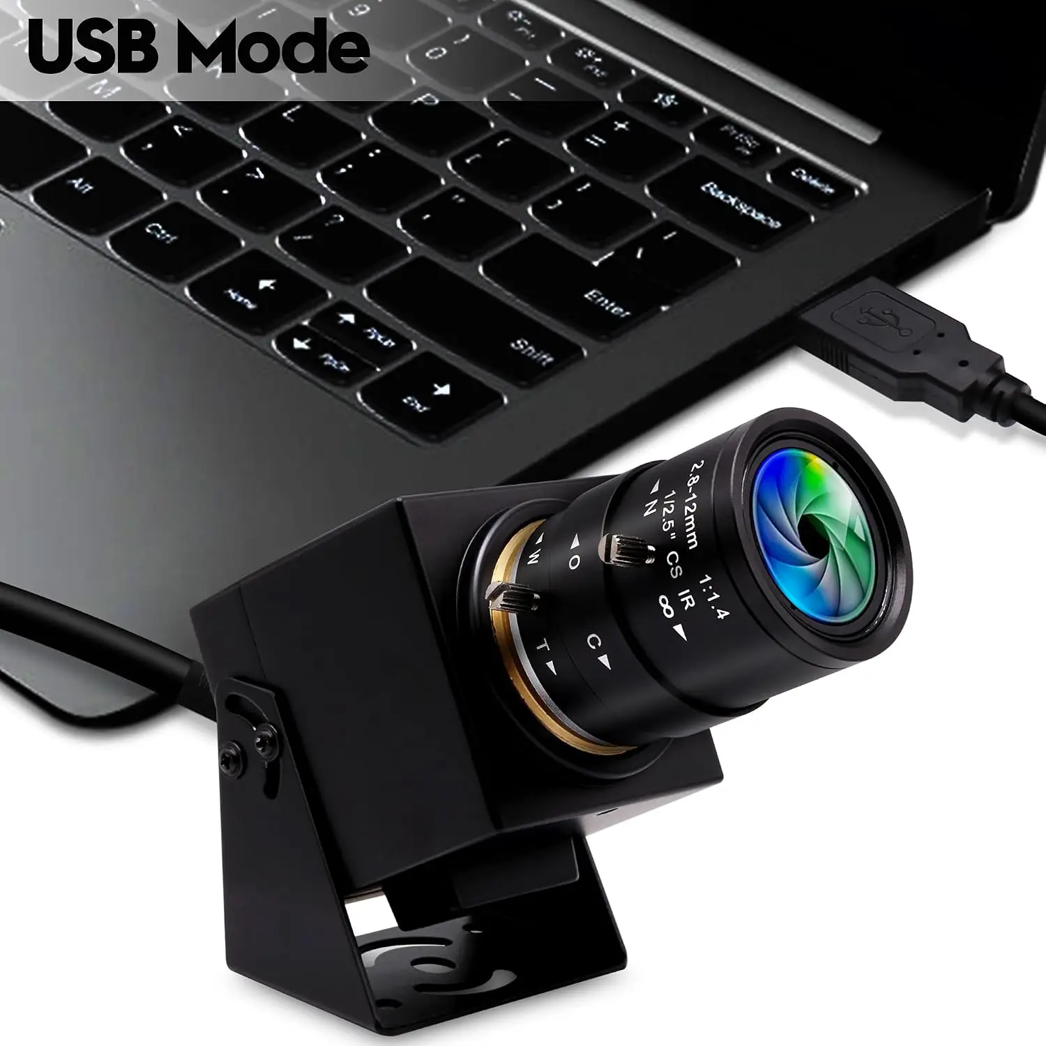 USB microscope mounted on a stand connected to a laptop, lens near the keyboard.