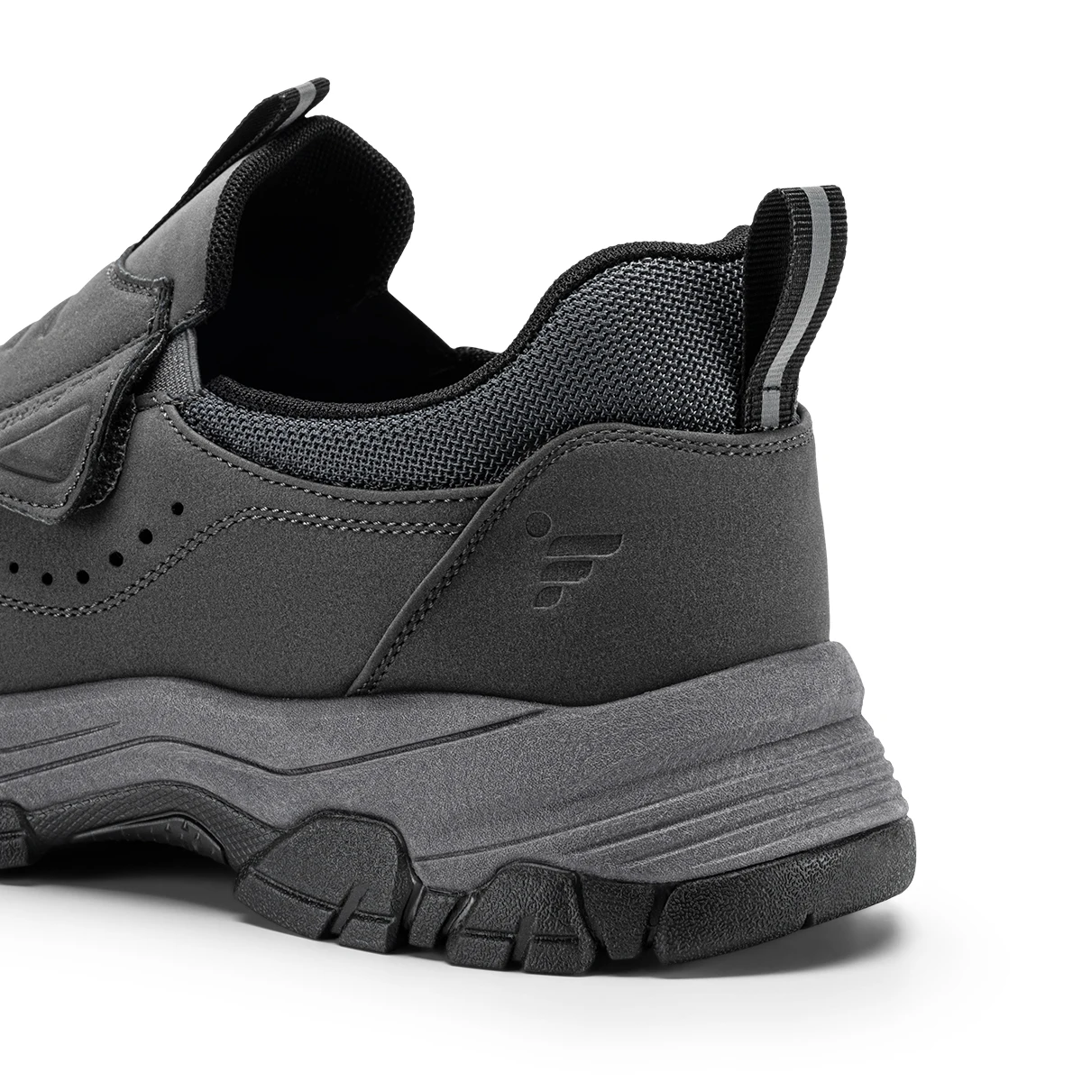 Close-up of a dark gray sneaker heel with padded collar, textured mesh, and chunky outsole.