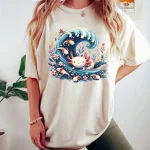 Womens Plus Size Axolotl Wave Tank Top 6 | PricZone Person wearing a white oversized Tshirt with a colorful cartoon wave and small sea creatures print on the front | PricZone