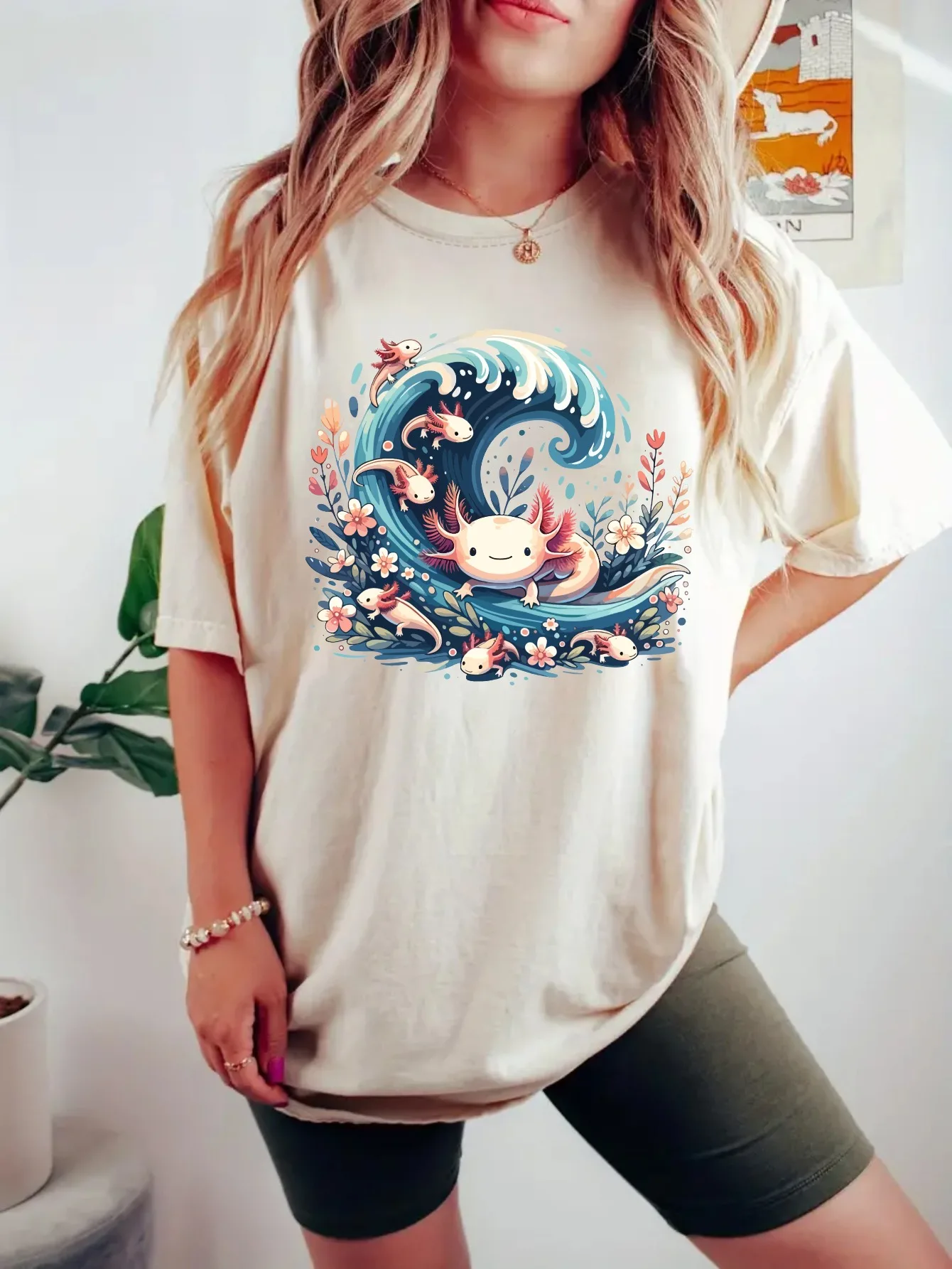 Womens Plus Size Axolotl Wave Tank Top 6 | PricZone Person wearing a white oversized Tshirt with a colorful cartoon wave and small sea creatures print on the front | PricZone
