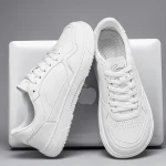 White athletic sneakers draped over a silver MacBook gray background | PricZone