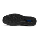 Bottom view of a black running shoe outsole with wavy tread and a blue cushioning window | PricZone