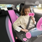 Piece Luxury Car Seat Cover Set with Soft Fluffy Steering 6 | PricZone Woman in a beige sweater buckling her seatbelt in a car with pink fuzzy interior accessories | PricZone