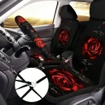 Front interior of a car with black seat covers and a steering wheel cover adorned with red roses | PricZone